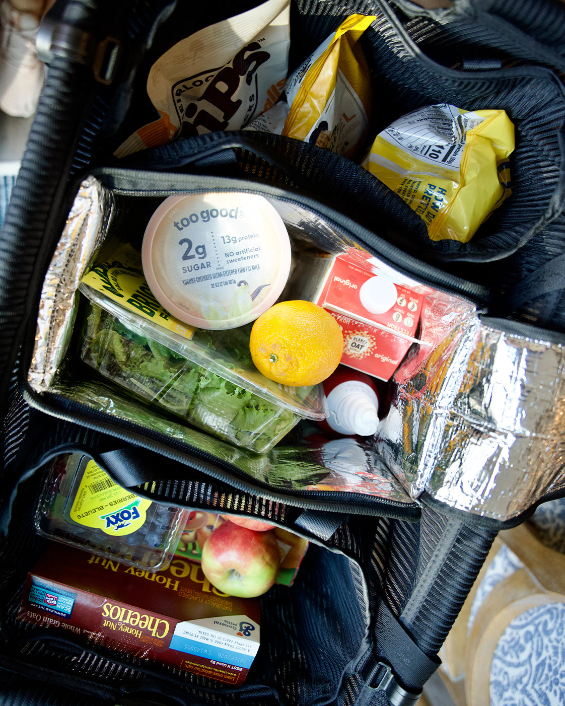 Overhead close-up of groceries inside the silver-lined Insulated Freezer Bag.